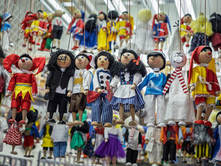 Fototapeta premium Variety Of Traditional Wooden And Cloth Hand Puppets Hanging On Strings Representing Different Costumed Characters, Prague, Czech Republic