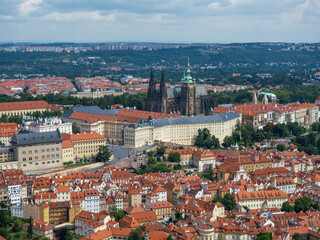 Fototapeta premium Panoramic View Of Prague Castle And St. Vitus Cathedral Above Densely Packed Red Roof Houses, Prague, Czech Republic
