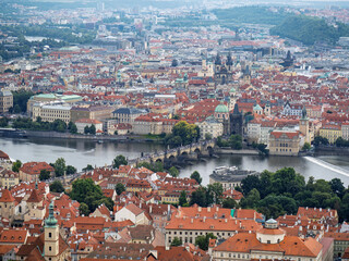 Obraz premium High Angle View Of Charles Bridge Crossing The Vltava River Among Historic City Center Buildings, Prague, Czech Republic