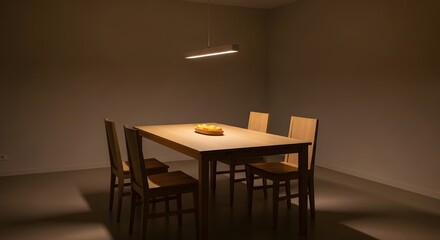 A minimalist dining room with a table and chairs under a hanging light fixture