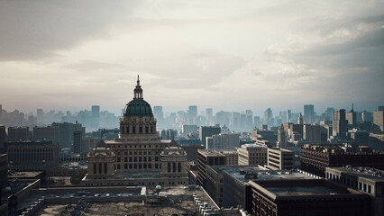 Obraz premium Aerial city view capitol dome with cranes, timelapse movement capturing expansion and infrastructure, overcast sky and heavy clouds, crane silhouettes