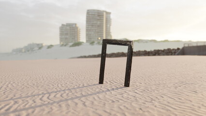 A black wooden frame stands upright on a sandy beach, surrounded by soft golden light during sunset. Tall buildings rise in the background, hinting at urban life nearby. © icetray