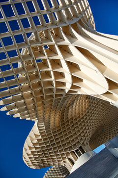 Low angle abstract view of the wooden lattice structure of the Metropol Parasol (Las Setas) in Plaza de la Encarnacion, Seville, Andalusia, Spain.