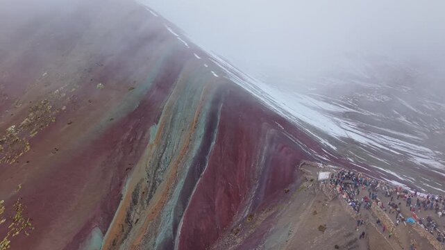 Stunning aerial of Rainbow Mountain's colors amid hazy skies, Peru