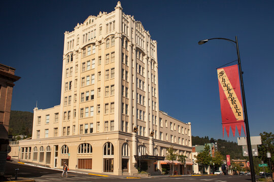 The historic Art Deco Ashland Springs Hotel on a Main St corner close to a "Shakespeare" banner in Ashland, Oregon