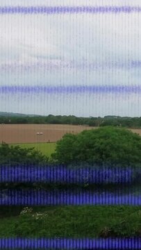 Vertical video: Operator tilting camera, panning up, exposing fields, stripes briefly flickering