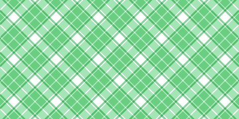 Green and white diagonal plaid pattern background. Seamless checkered tartan texture for St. Patrick's Day, spring fashion, wrapping paper, and textile design. Classic preppy geometric fabric style.