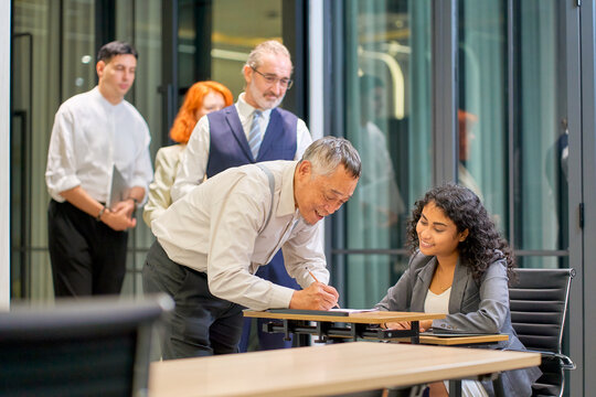 A businessman register in business class with staff for seminar in meeting room , Co-working space.