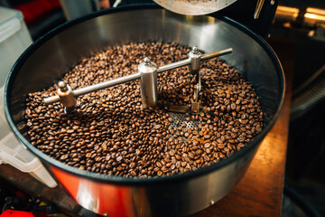 reshly roasted coffee beans mixing in a commercial coffee roaster machine.