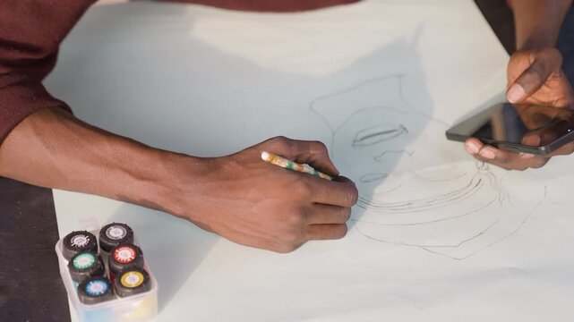 Black painter referencing phone while painting portrait on paper, translating dotted sketch into bold contours with watercolor and gouache. Warm workshop light, energetic hands, precise strokes,