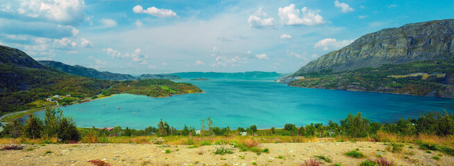 Rocky beach, beautiful arctic bay, mountain landscape with blue sky and sea, Trolls from pebbles. Wild nature Norway, seascape. © vvvita