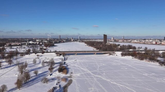 Sunny Winter Cityscape with River and Bridge