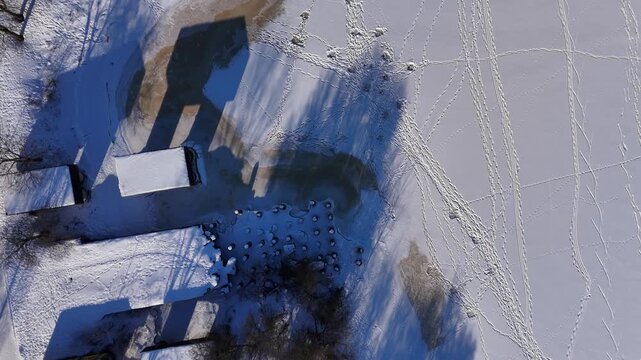 Winter River with Footprints from Above