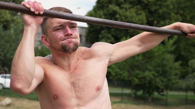 Sportsman performing intense pull-up workout, showcasing strength and determination, with focus on muscular effort and outdoor training environment, capturing essence of physical fitness progression