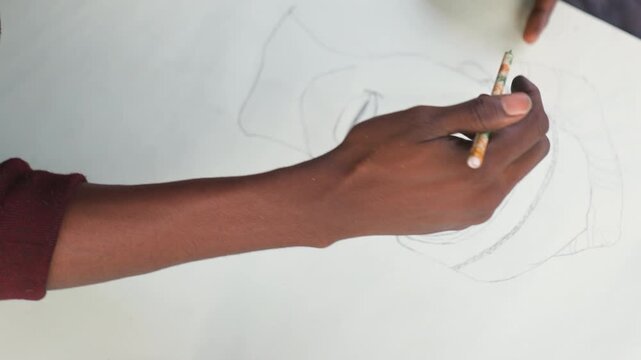 Artist sketches vividly. Creative artist working on portrait. Skilled creator drawing headwrap with bold outlines. Black artist passionately sketching headwrap portrait with rhythmic motion