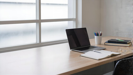 Fototapeta premium Minimalist Workspace with Laptop and Notebook by Window Natural Light