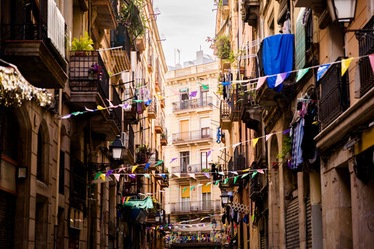 old street in old center of barcelona in spring day in the raval district