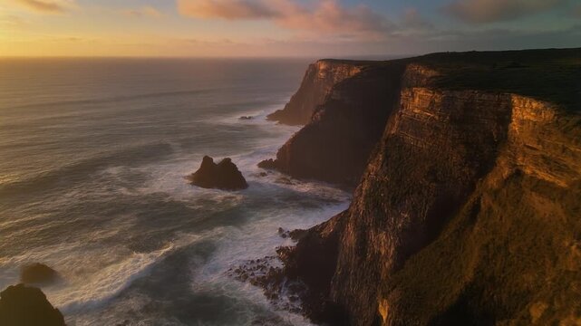 Cinematic footage of ocean from coastal cliffs during sunset, warm light illuminating cliffs and water, ultra-realistic 4K HDR, smooth drone pan and tracking motion, clean footage, no humans, no logos