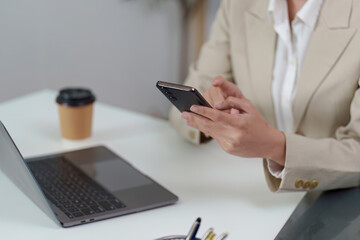 Professional woman using smartphone in modern office environment