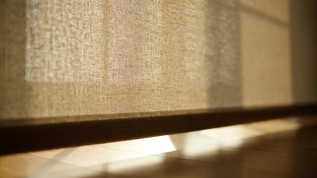 Bright sunlight streams through a window with blind, casting shadows on wood floor. Interior detail, daylight, home, indoor, bright, and sunlight.
