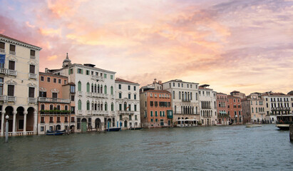 Obraz premium Venice palazzos on Grand Canal with motorboat at sunset