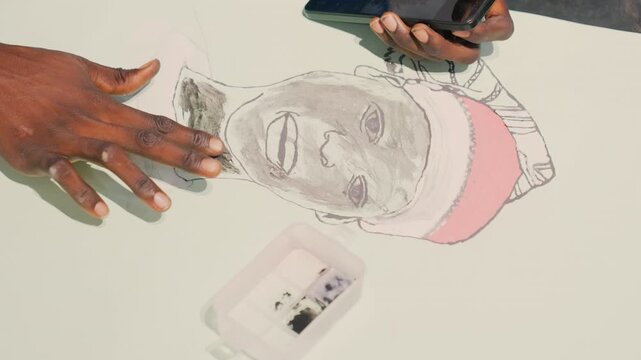 Portrait highlighting detailed. Closeup of artwork details. Artist carefully applying last touches to image. Precise finishing of portrait with delicate highlights and accessory emphasis