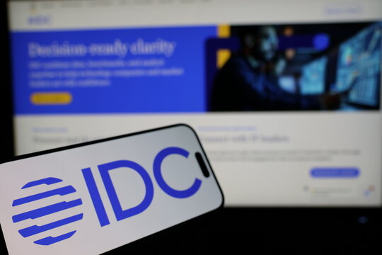 Kiel, Germany - 02-27-2026: Smartphone displaying US market intelligence company IDC logo in front of companys webpage