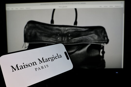Kiel, Germany - 02-27-2026: Smartphone displaying French fashion house company Maison Margiela logo in front of companys webpage