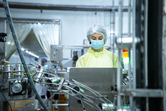 Quality control officers inspect the can conveyor system