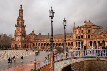 Plaza de Espana, Sivilla. Historic stone building with towers and courtyard under cloudy sky © Giammarco Figus