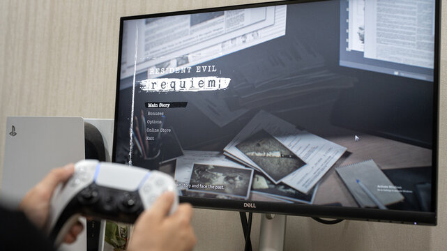 Bangkok, Thailand - 27 March 2026; A gamer is playing the Resident Evil Requiem, the legendary game from Capcom that is global launch today. Close-up and selective focus on screen.