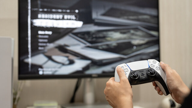 Bangkok, Thailand - 27 March 2026; A gamer is playing the Resident Evil Requiem, the legendary game from Capcom that is global launch today. Close-up at the hand which is holding controller.