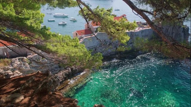 Scenic panoramic seascape of Petrovac Riviera Montenegro with green rocky mountains and sparkling blue Adriatic Sea