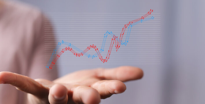 Hand holding a graph representing financial growth and success, business analysis and progress, economic trends and posi