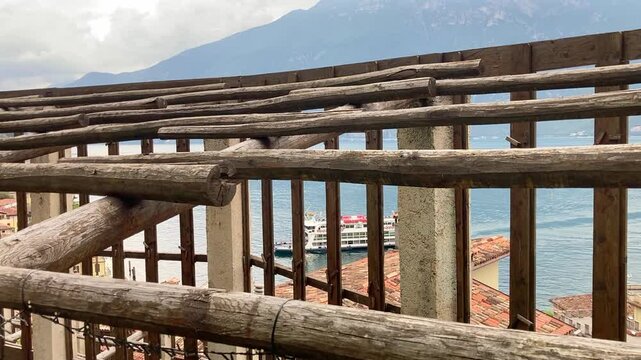 Limone sul Garda, Italy Lemon grove, view to the Garda lake with a tourist Ferry approaching the pier