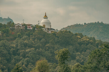 Fototapeta premium World Peace Pagoda Shanti Stupa on Hill in Pokhara Nepal with copy space