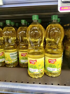 Saujon, France - January 24, 2026: Intermarche. Bottles of Bouton d'Or colza oil displayed on supermarket shelf, bright yellow packaging with green caps and labels visible