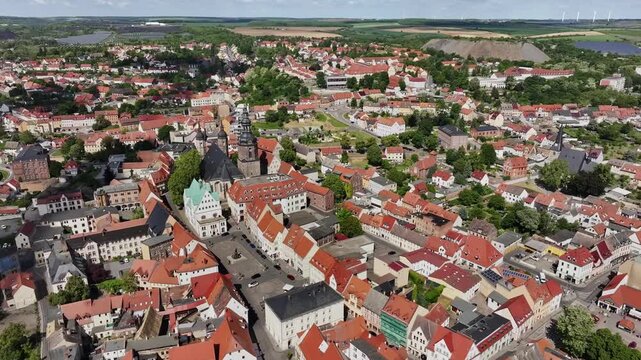 The city center of Luthertown Eisleben in summer, half-timbered houses in the center, slag heaps on the outskirts. A city of many churches in Saxony-Anhalt.