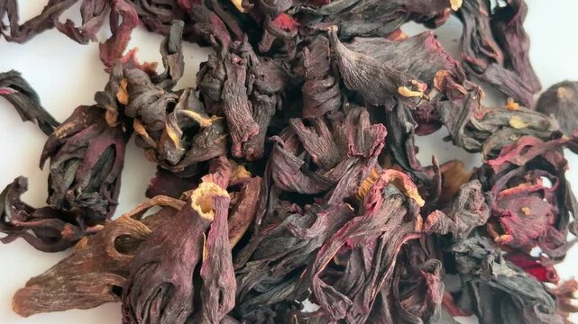 Close-up of deep red hibiscus petals with a natural texture, ideal for visualizing tea, health, and culinary products.