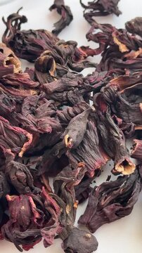 Close-up of deep red hibiscus petals with a natural texture, ideal for visualizing tea, health, and culinary products.