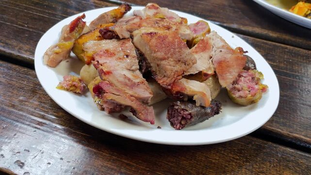 Large rustic board with pork, beef, chicken, morcilla and chorizo