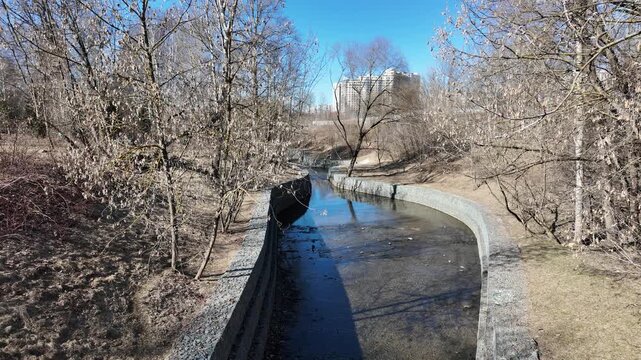 stone pavement along the banks of a river in a city park