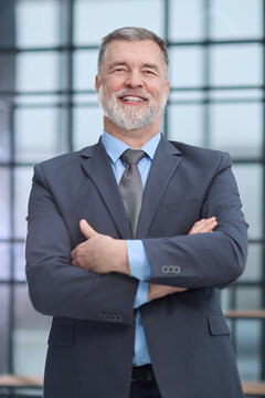 A man in a suit and tie is smiling and looking at the camera