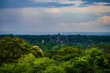 Fototapeta premium Ancient Angkor Wat temple rising above lush Cambodian jungle