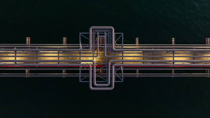 Obraz premium Aerial view industrial oil and gas pipeline system, Energy industry pipeline structure oil and gas refinery, Industrial pipeline system petrochemical plant refinery, Petrochemical pipeline network.