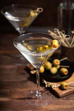 Martini cocktail with olives on a bamboo pick