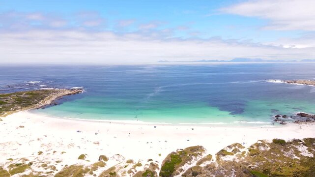 Secluded sandy Moonlight beach at Pringle Bay with scenic turquoise water, drone