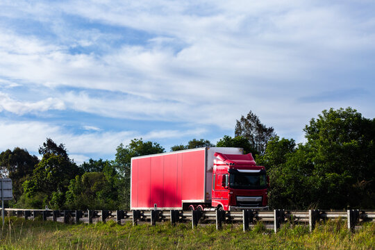 red truck traveling in left lane on divided highway road in NSW Australia