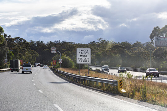 trucks and busses must use left 2 lanes sign beside highway with 90 speed sign
