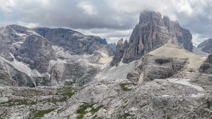 Aerial, bird view, drone view, Italy. very impressive rocky mountains and peaks. Italian mountain landscape, cloudy summer day. Amazing oudoor hiking travel destination, Dolomites. Outdoor adventure.